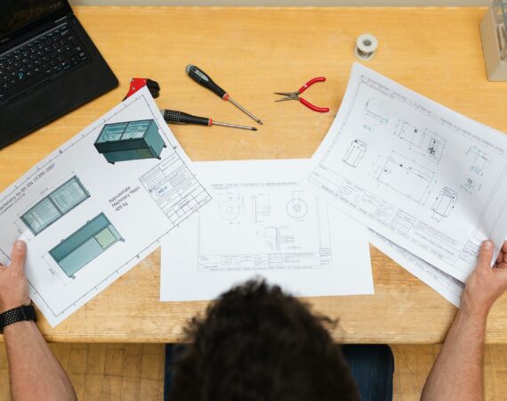 Worker at desk with various papers